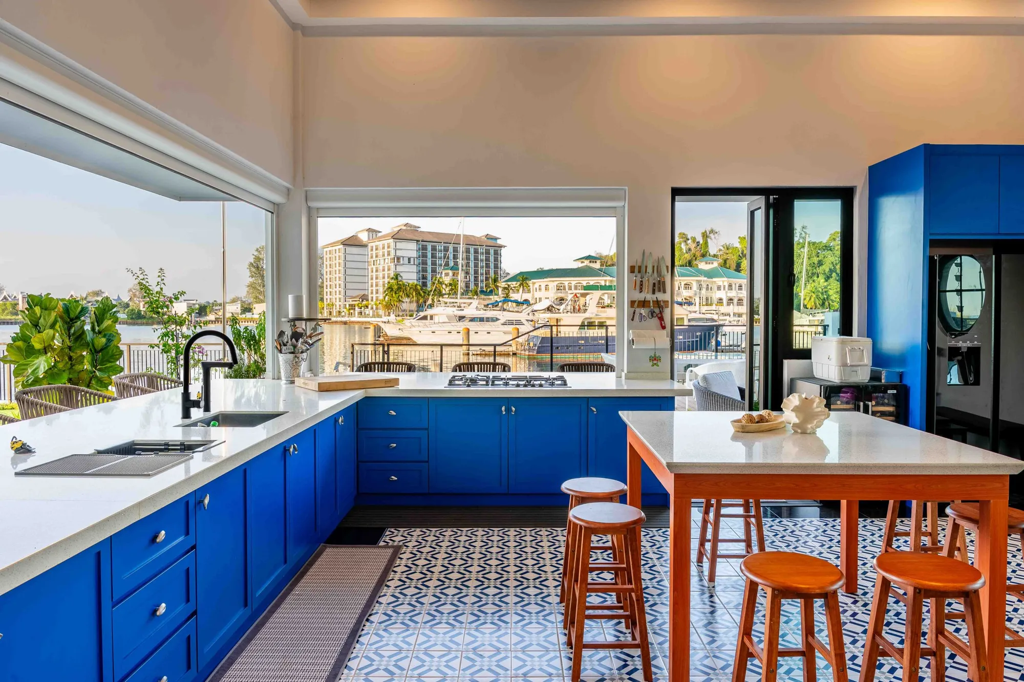 Waterfront villa living space with floor-to-ceiling glazing — villa interior design by Blaine Robert Design